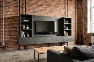 Salon loft industriel avec mur en briques apparentes rouges et meuble TV en placo design noir mat sur sol béton ciré